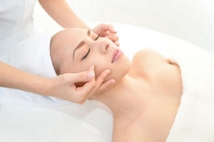 18475564 - pretty woman receiving facial massage